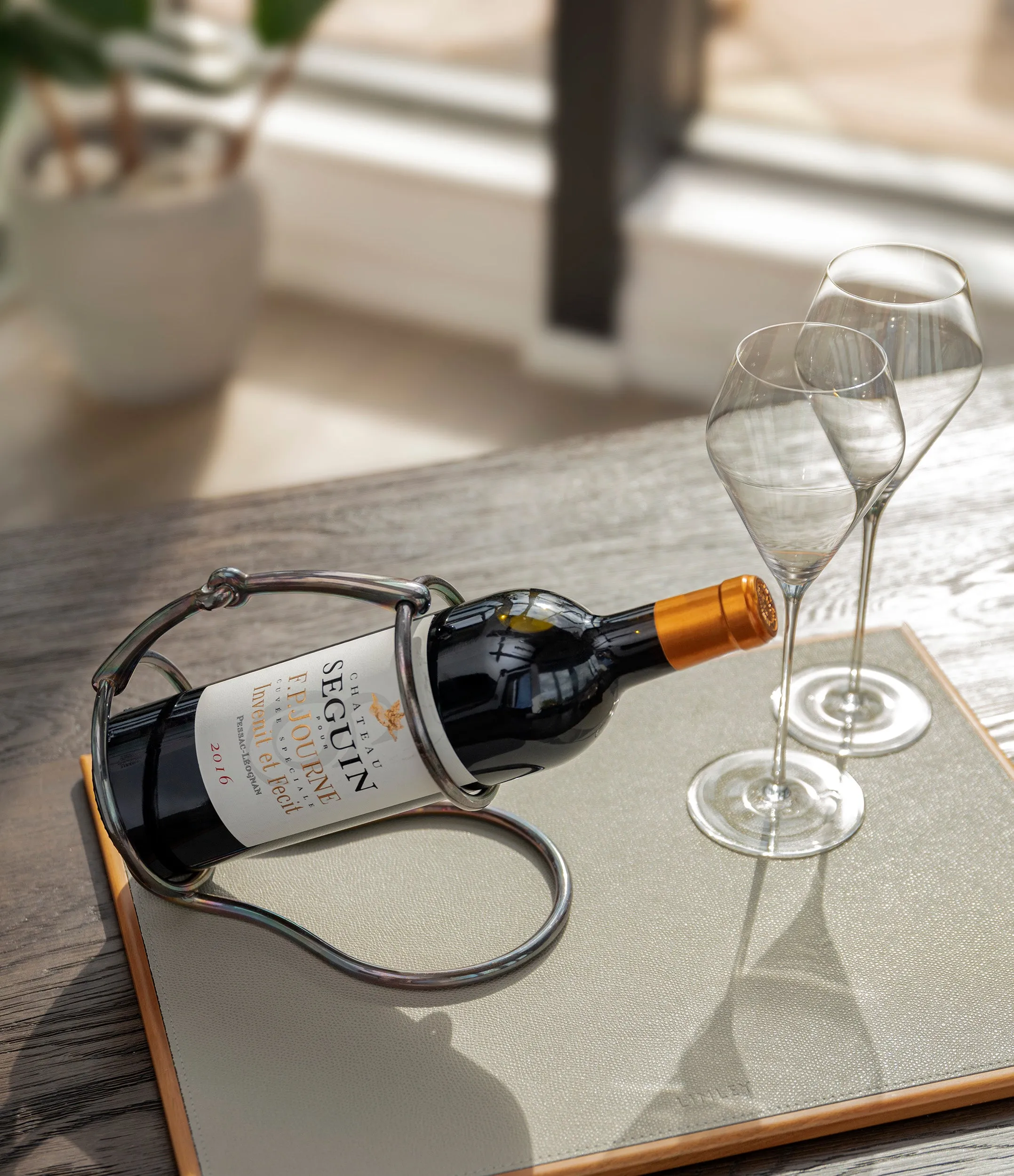 Hermès wine bottle holder | silver-plated with iridescent patina
