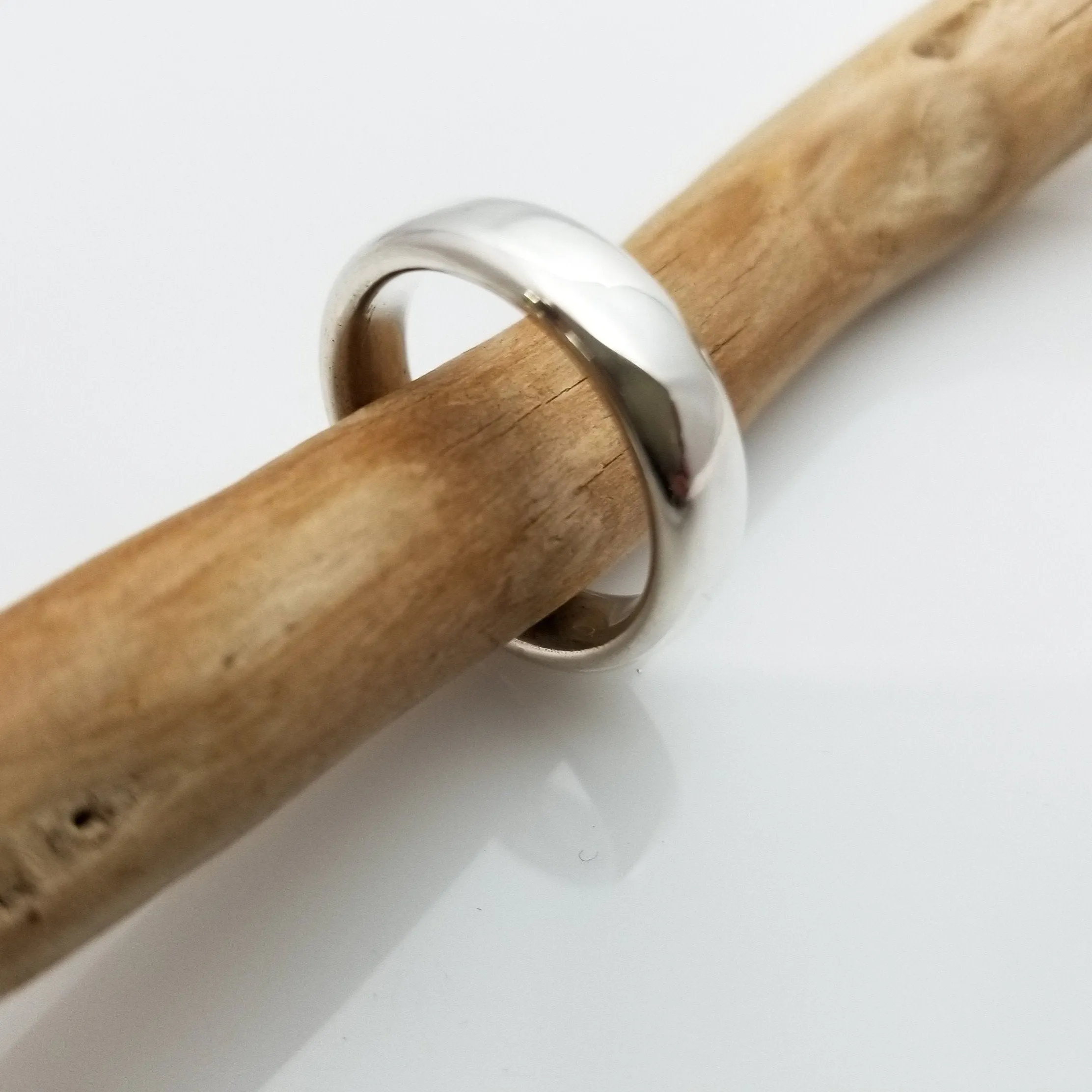 "New Moon Ring, Timeless Elegance: The Classic Solid Silver Wedding Band"
